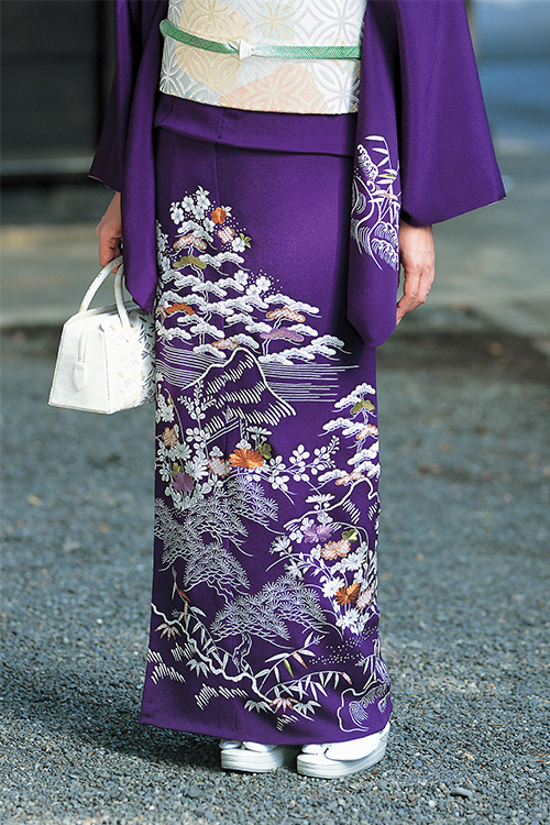 dressed in a black-purple kimono with moon-shaped white accents
